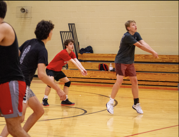 Players of the volleyball team practice at the Fishers New Aux Gym on May 16, 2024. Cameron Benson (second from the right) and junior Davis Theobald (far right) worked to receive the incoming serve from the other side. Photo by Vi Tran.